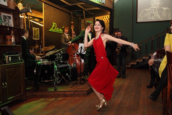 Picture of Ksenia Parkhatskaya swing dancing in a red dress in a blog about Dance Shoes