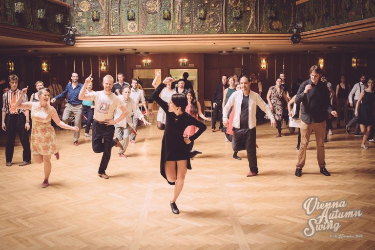 Photo of Ksenia Parkhatskaya teaching swing and solo jazz dancing to a big class
