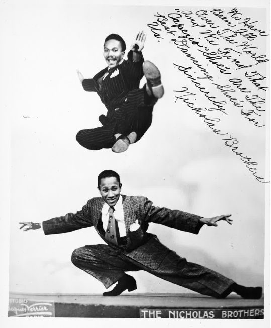 Nicholas Brothers performing with dynamic arm movements in solo jazz